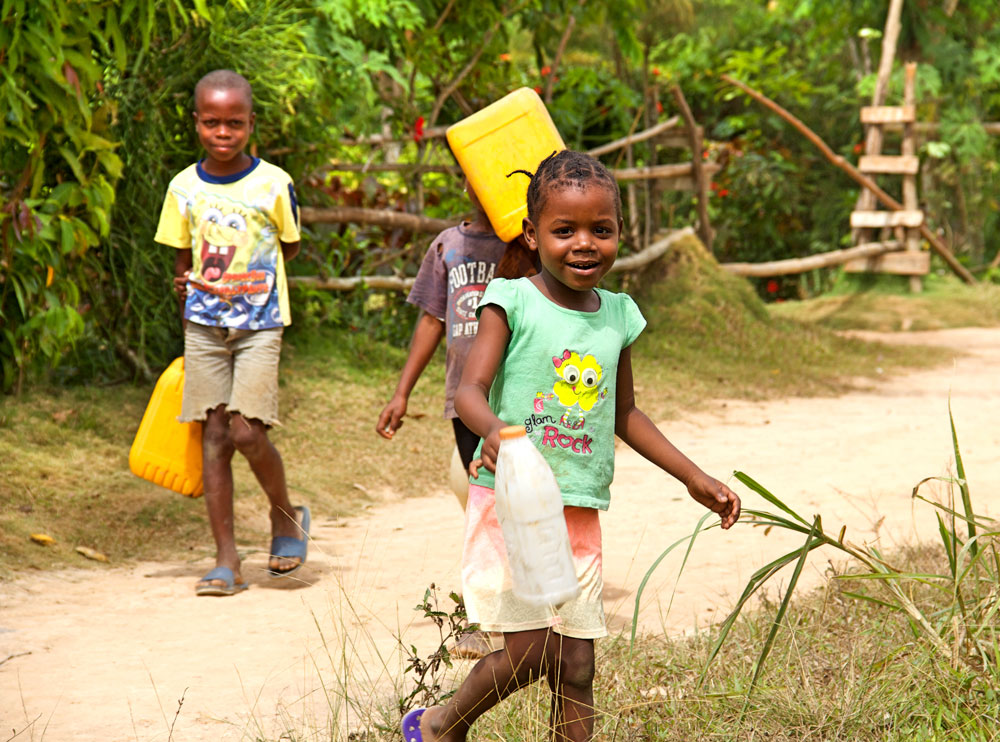 children gathering freshwater in haiti