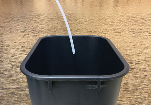 place the sample discharge line into an empty collection container