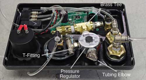 solinst 464 electronic pump control unit back of faceplate panel showing t fitting and pressure regulator and tubing elbow