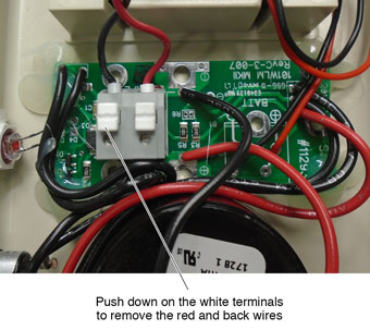 push down on white terminals to remove red and black wires for solinst power reel electronics