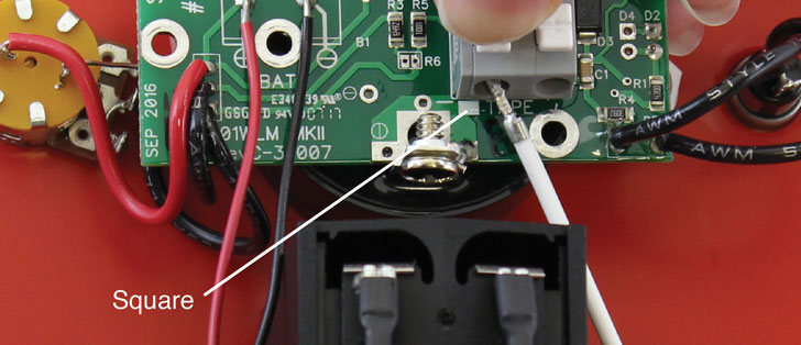 connect the tape to the circuit board assembly by pressing down on the white terminals on the circuit board and inserting the tape leads