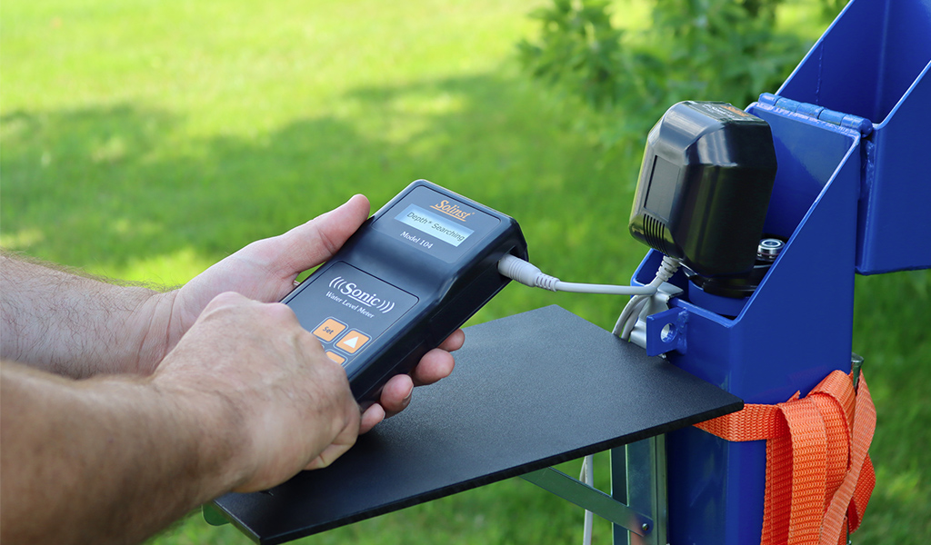 solinst sonic water level meter being used to record static water levels at groundwater monitoring well