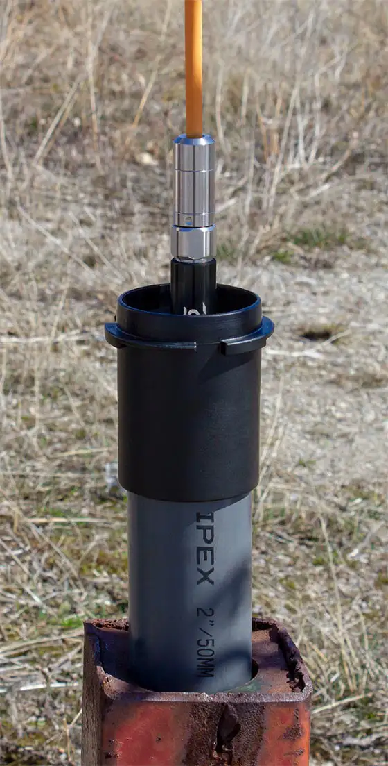 Solinst Levelvent 5 Vented Water Level Datalogger Being Lowered Into 2 Inch Locking Well Cap solinst levelvent 5 vented water level datalogger being lowered into 2 inch locking well cap